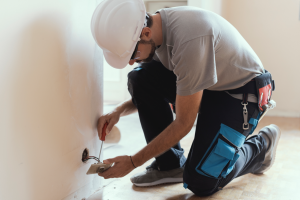 Electrician installing an outlet in a house in Port St. Lucie, Florida