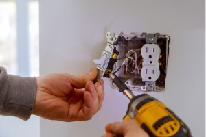 Electrician repairing an outlet at a house in Belleview, Florida